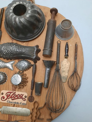 Collection of vintage pastry tools on wooden board