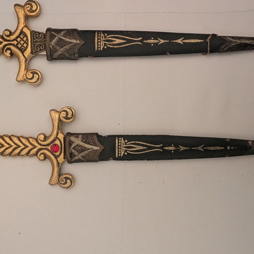 Decorative Spanish stiletto knives with gold handles and black sheaths