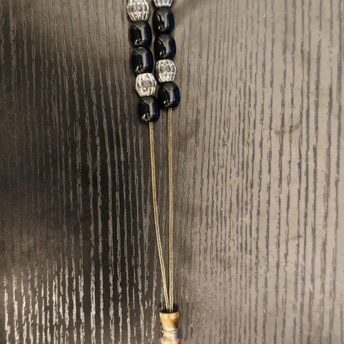 Black worry beads used with metal chain and details