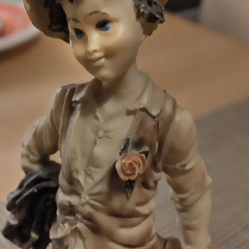 Decorative vintage figurine on wooden base like new