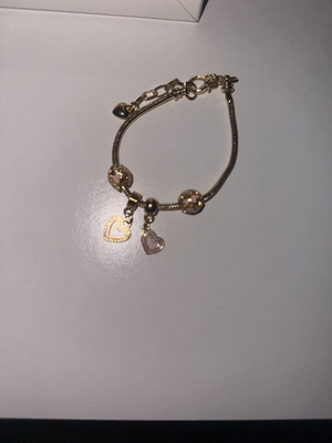 Gold bracelet with 4 charms, new