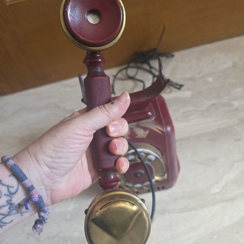 Metal telephone used, red, wired connection