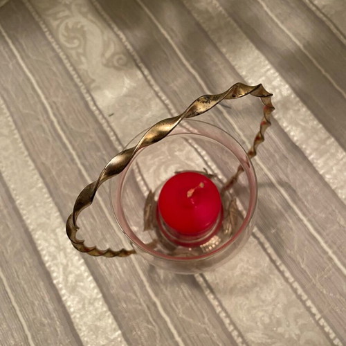 Metal candle holder with glass container used with candle