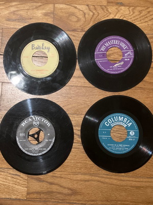 Mini collection of 17 used 45 rpm vinyl records with foreign songs in album