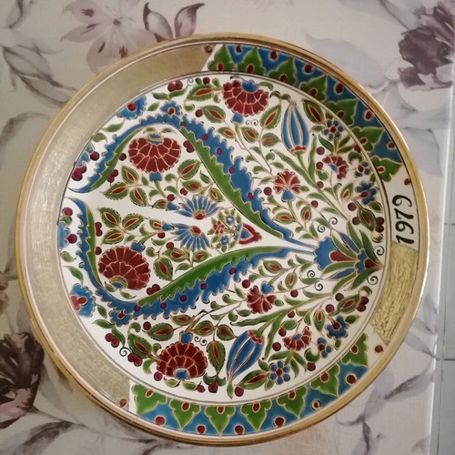Ceramic wall plate used with gold details