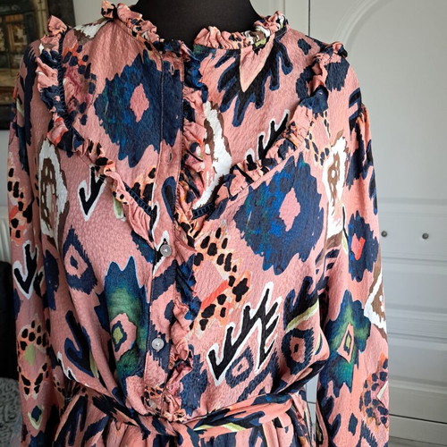 Pom dress used with geometric pattern in pink, blue and green