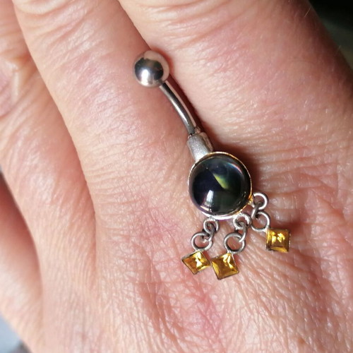 Aurora borealis navel piercing with color-changing crystal