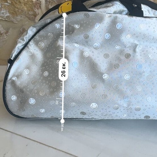 Smiley metallic travel bag used with embossed smiley and star designs