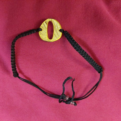Bracelet with letter O used, black and gold adjustable cord