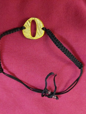 Bracelet with letter O used, black and gold adjustable cord