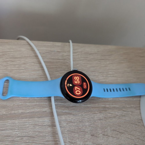Google Pixel Watch 2 with charging base and extra metallic band