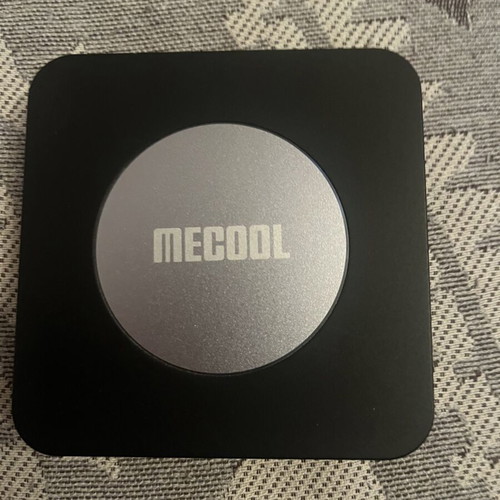 Mecool KM2 Plus TV box with charger and remote