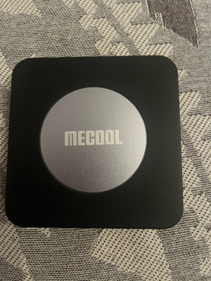 Mecool KM2 Plus TV box with charger and remote