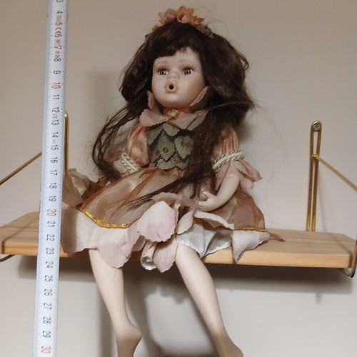 Porcelain doll sitting pose