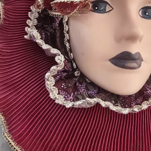 Decorative porcelain wall mask used with fabric hat in burgundy