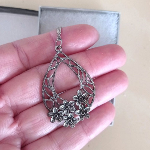 Chain with large motif used, silver with floral decoration