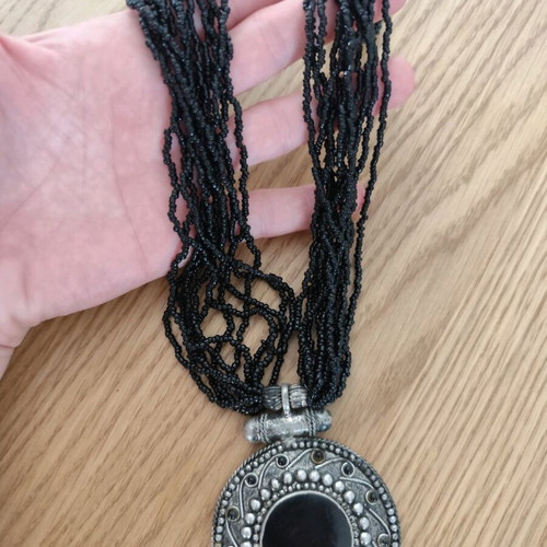 Long necklace with round pendant and bells, like new