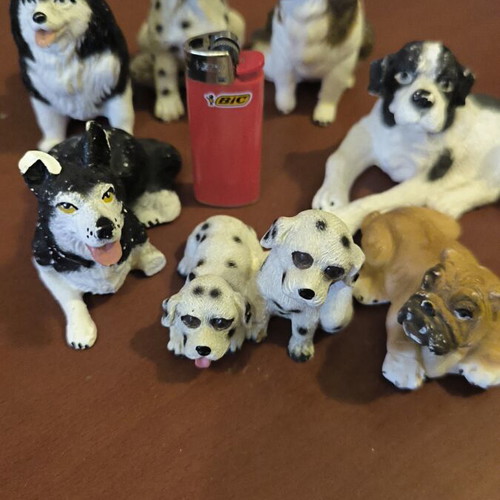 Gypsum dog figurines like new, set of 8 with one broken