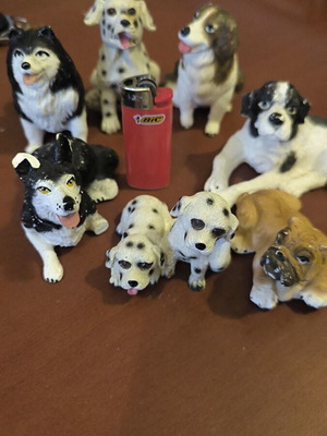 Gypsum dog figurines like new, set of 8 with one broken