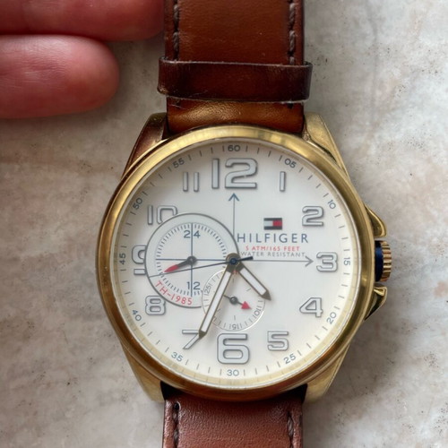 Tommy Hilfiger watch used with brown leather strap and gold dial