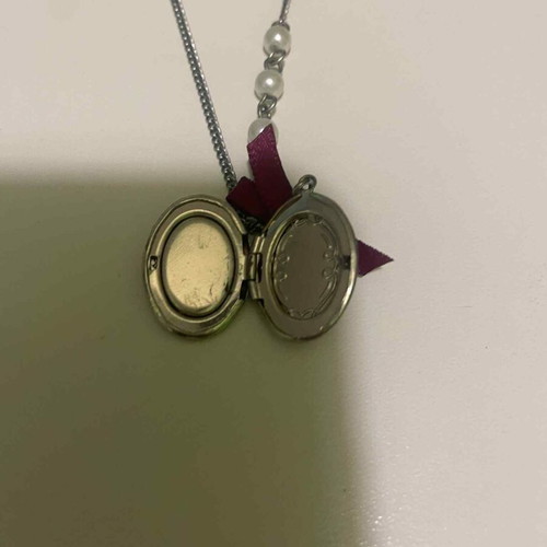 Pendant used with silver chain, pearls and retro bow