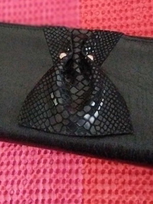 Black handheld envelope bag like new with animal detail and two buttons