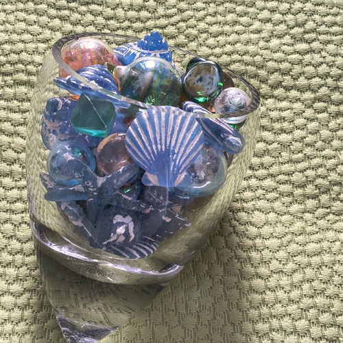 Glass decorative piece with blue sea-themed marbles and stones