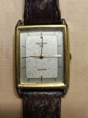Orient watch used with brown leather strap and gold color