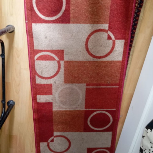 Vintage carpet runner used with geometric motifs in warm colors