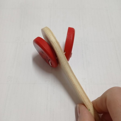 Wooden clapper used with red ladybug
