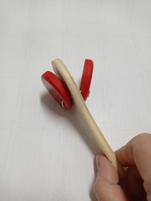 Wooden clapper used with red ladybug