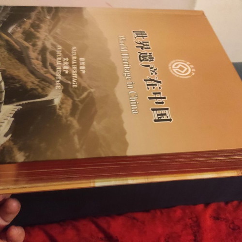 Collectible gold-bound volume with China stamps and photos