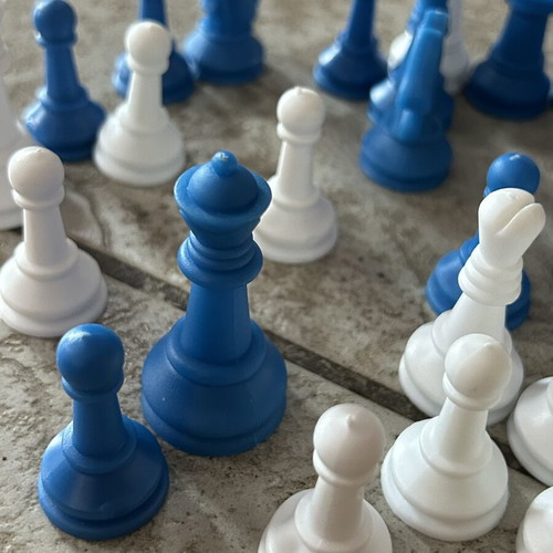 Vintage blue and white plastic chess pieces set
