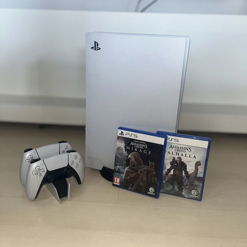PlayStation 5 console used with two Assassin’s Creed games and DualSense controllers