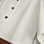 White short jacket with stand-up collar and buttons, minimal style