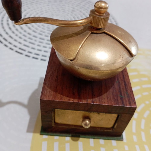 Vintage miniature manual coffee grinder with wooden body and brass hopper