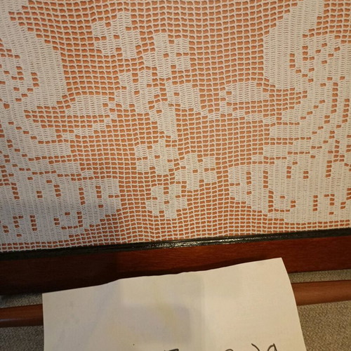 Handmade carved frame with crocheted peacocks design