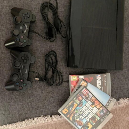 PlayStation 3 console with controllers and games