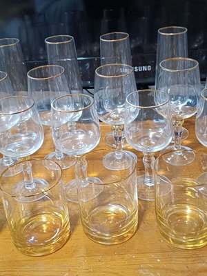 Set of water, wine, champagne and whisky glasses with gold rim, new