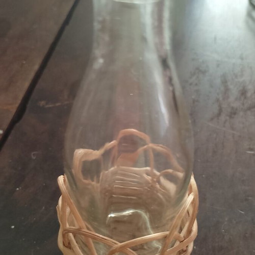 Miniature vintage bottle with wicker covering
