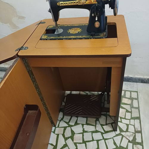 Singer sewing machine with cabinet used, motor and pedal included