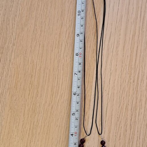 Necklace with black cord, burgundy polygonal beads and hematite key pendant like new