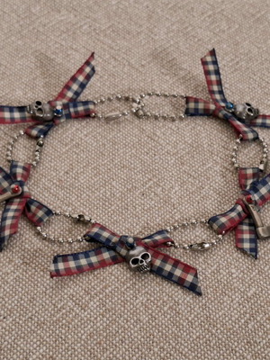 Necklace with checkered bows and small skulls like new, blue and silver