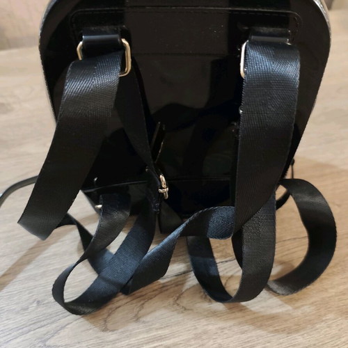 Small black backpack used with decorative patches
