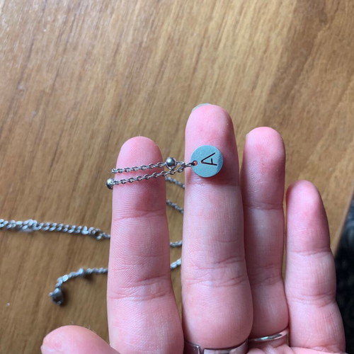 Steel necklace with letter alpha like new
