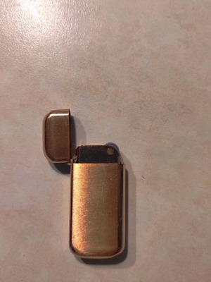 Small old lighter used, metal gold color