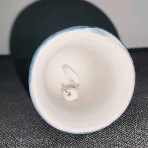 Ceramic bell used with embossed flower designs