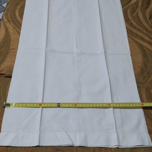 Set of 2 white pillowcases used for sleeping