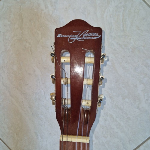 Classical guitar used with case, missing one string and small hole
