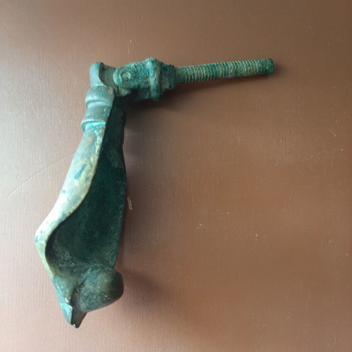 Antique bronze door knocker in hand shape